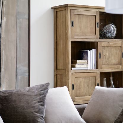 living room with white wall and wooden shelves