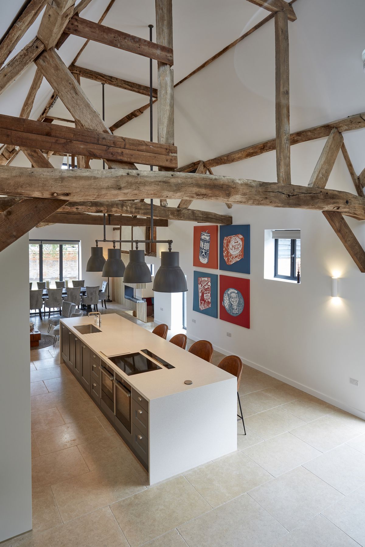 white large open plan kitchen with timber beams above
