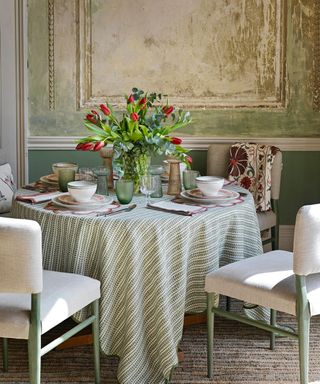 Round table, green and white tablecloth, green and white chairs