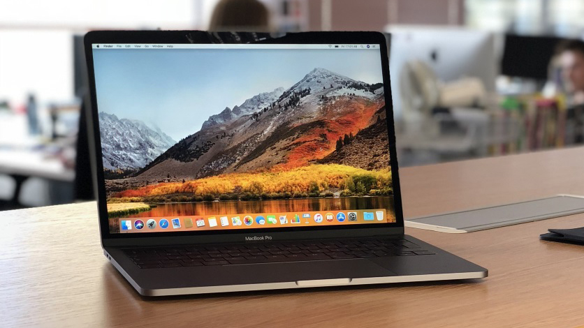 A MacBook Pro 2018 sitting on a desk in an office