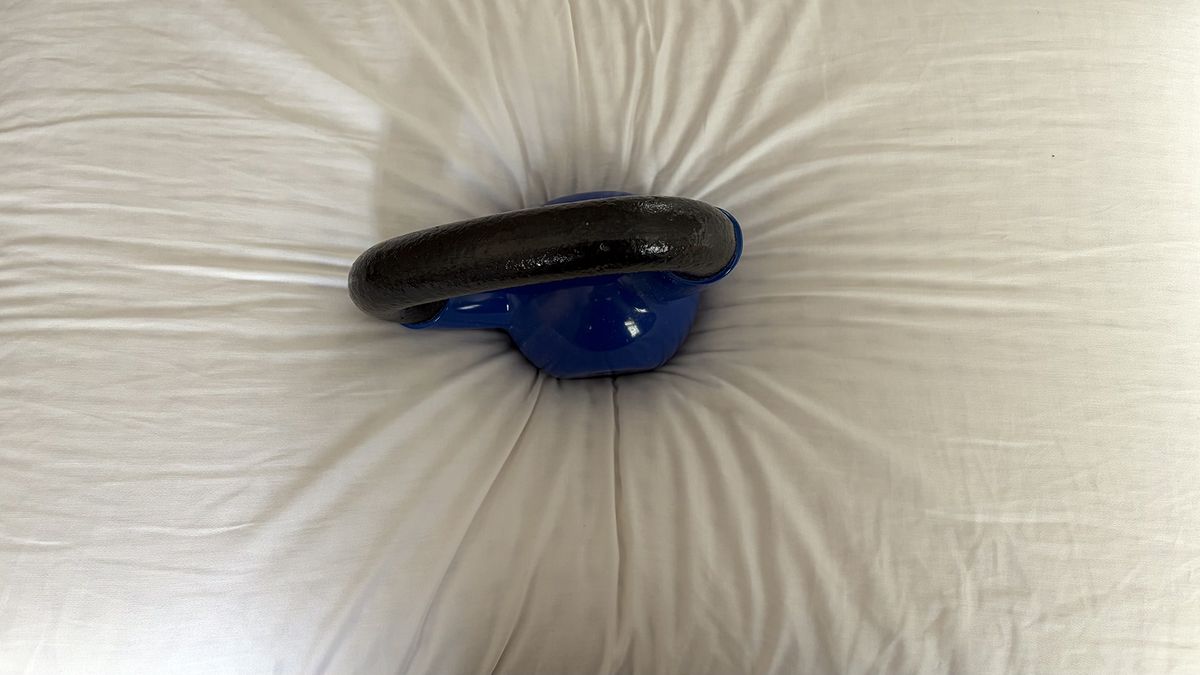 A close up of a 10lb kettlebell sitting on the Bearaby SoftForm Pillow