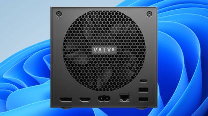 Back view of Steam Machine with Valve logo on fan grill and Windows 11 default ripple wallpaper in backdrop.