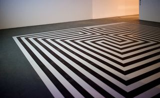 The floor of the event space has received a makeover by Patternity, featuring a striped decal inspired by labyrinths