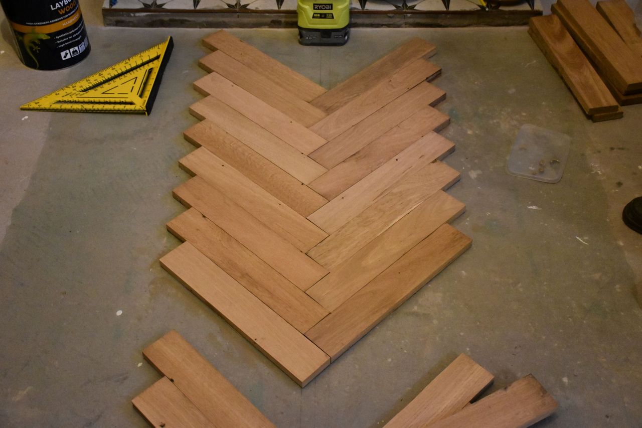 Dry laying the wooden blocks on the subfloor before sticking them down