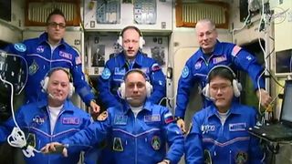 The International Space Station's full Expedition 54 crew speaks to family members and mission officials from the Zvezda control module after the arrival of NASA astronaut Scott Tingle (bottom left), cosmonaut Anton Shkaplerov (bottom center) and Japanese astronaut Norishige Kanai (bottom right) on Dec. 19, 2017. Also pictured are: NASA astronauts Joe Acaba (top left), cosmonaut Alexander Misurkin (top center) and NASA astronaut Mark Vande Hei.