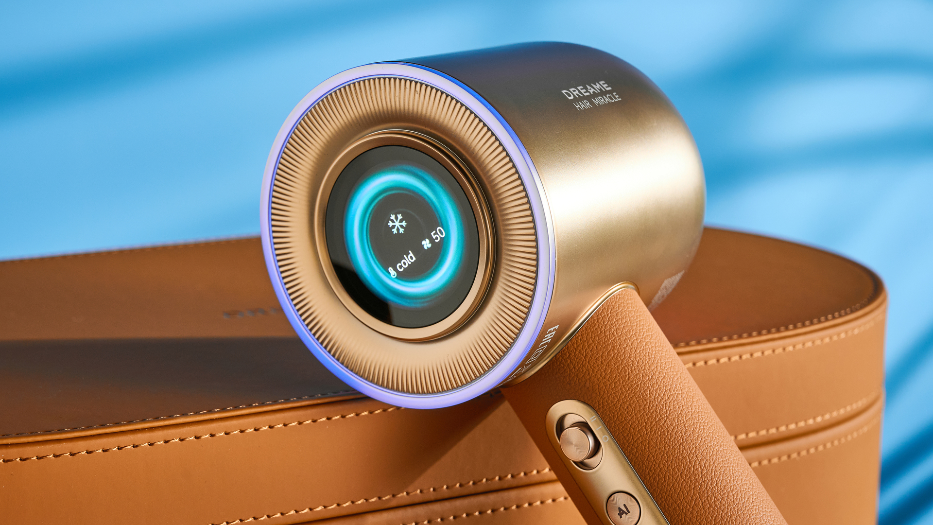 the dreame miracle pro hair dryer in gold showing the storage box on the blue tom's guide background, with the four attachment nozzles including two blow-drying nozzles, diffuser, and the flyaway tamer