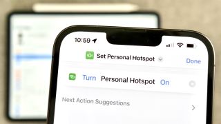 Photography of the Set Personal Hotspot action open in Shortcuts for iPhone, with an iPad visible in the background.