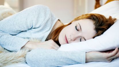 woman lying asleep in bed 
