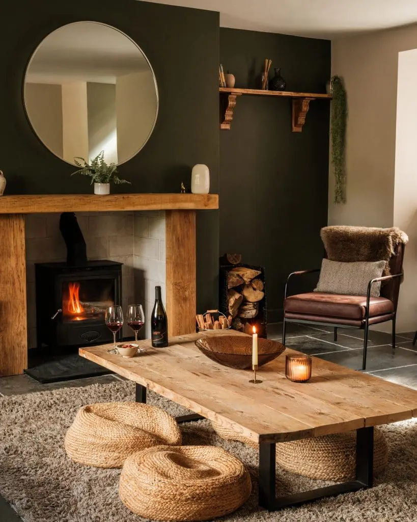 A modern rustic home features wooden furnishings mixed with rattan cushions, fuffly rugs, Western leather armchairs, and sleek mirror accents.