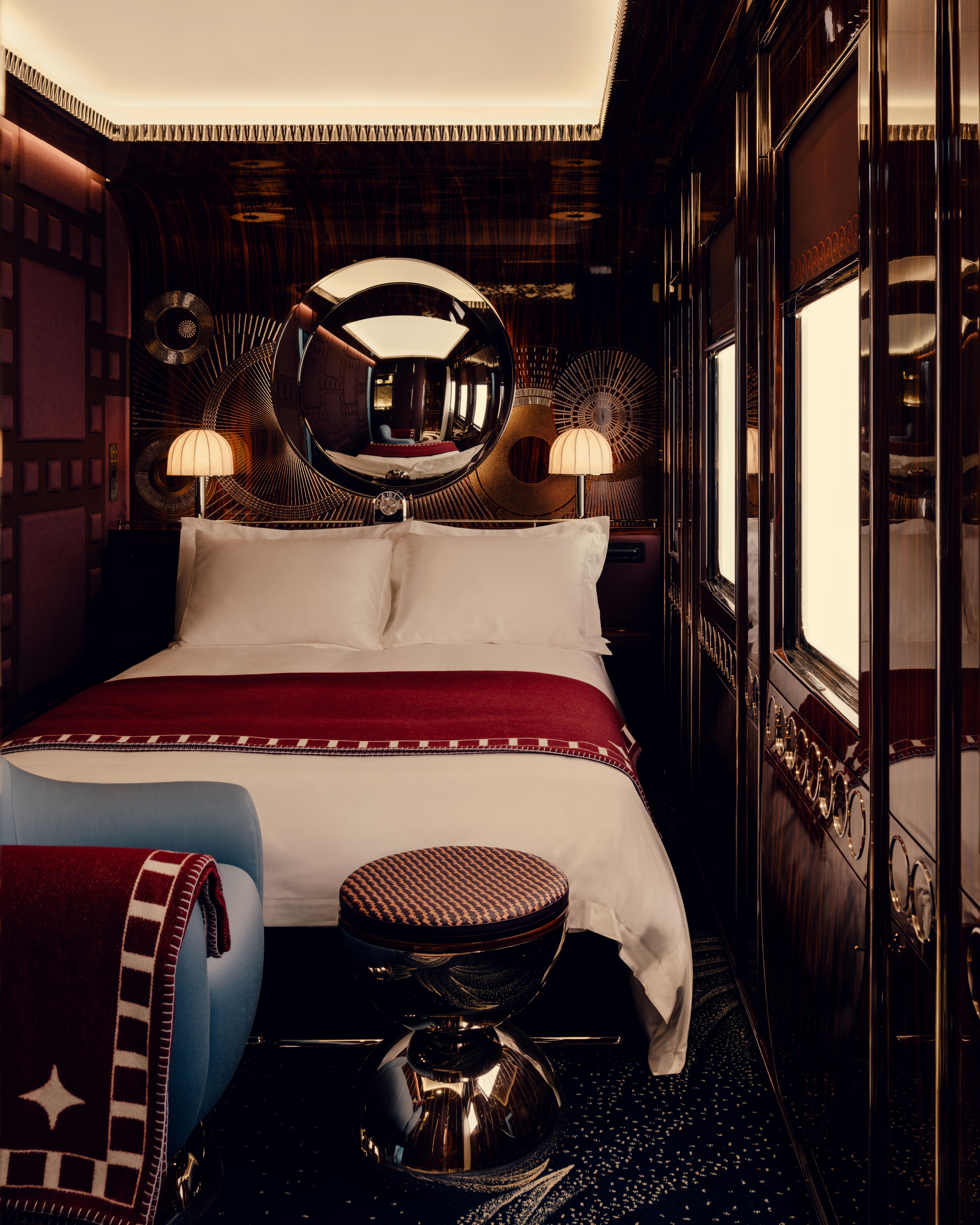 A series of images showcasing the vintage-inspired interiors of a luxury train, characterized by lacquered marquetry, plush textiles, geometrical patterns, and a chocolate, gold, cherry plum, green, and baby blue palette.