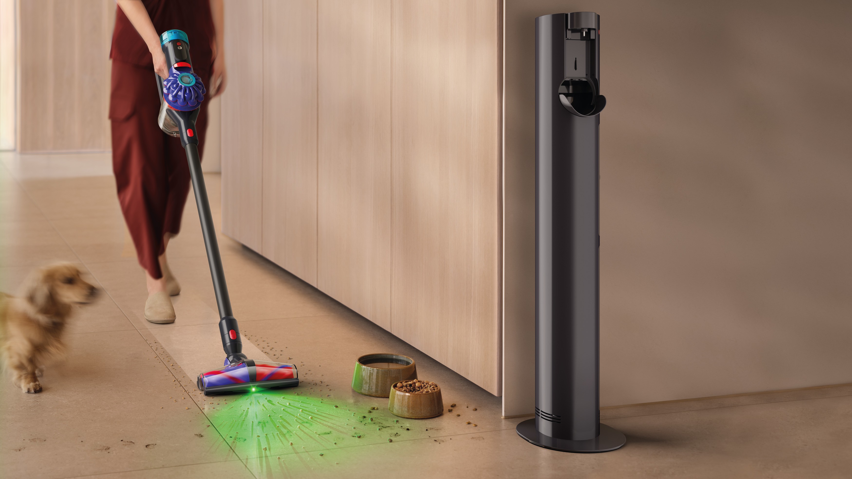 Dyson V10 Konical being used to clean up spilled pet food