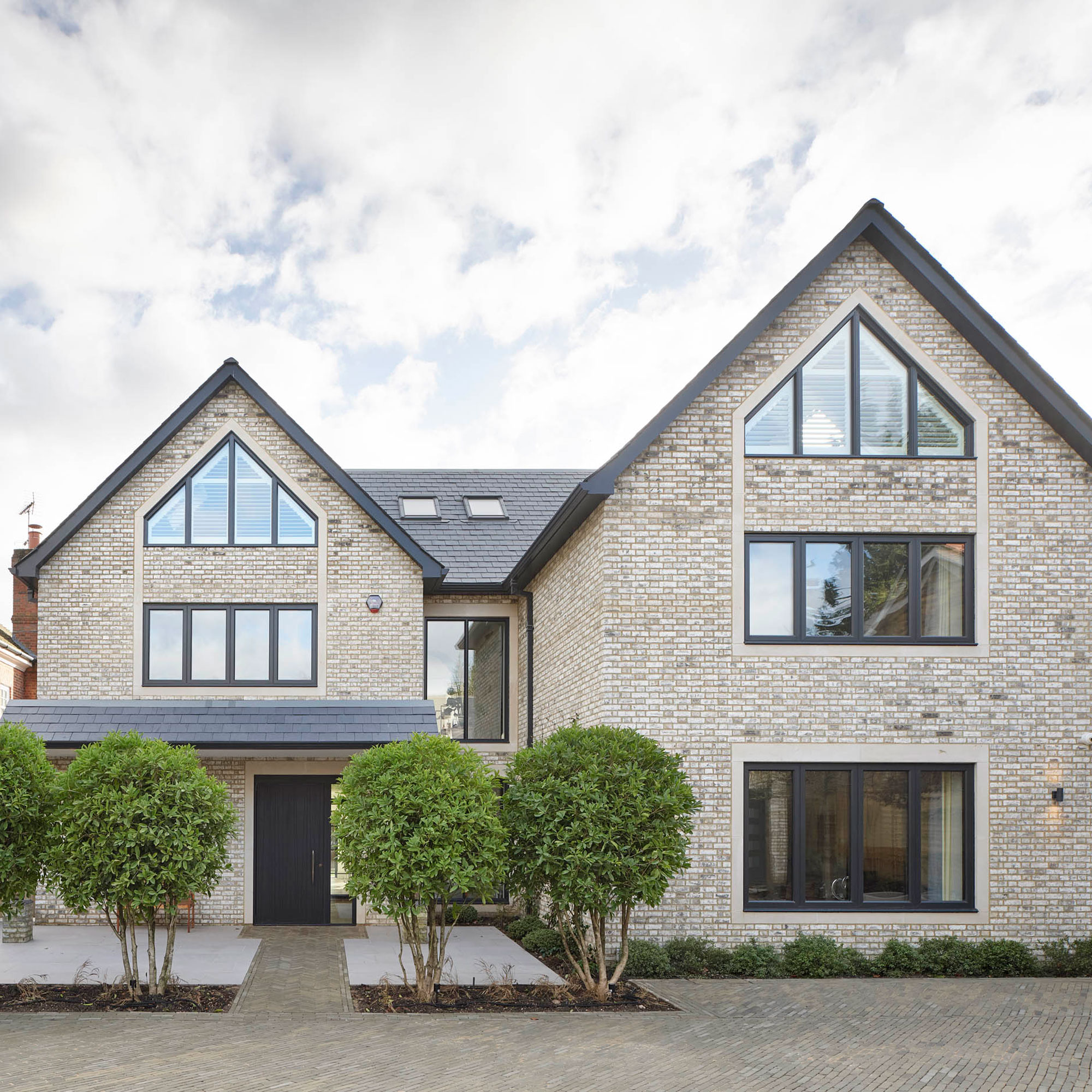 modern house with block paved driveway