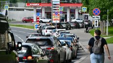 Cars wait in a long line at a gas station in Moscow amid fuel shortages.