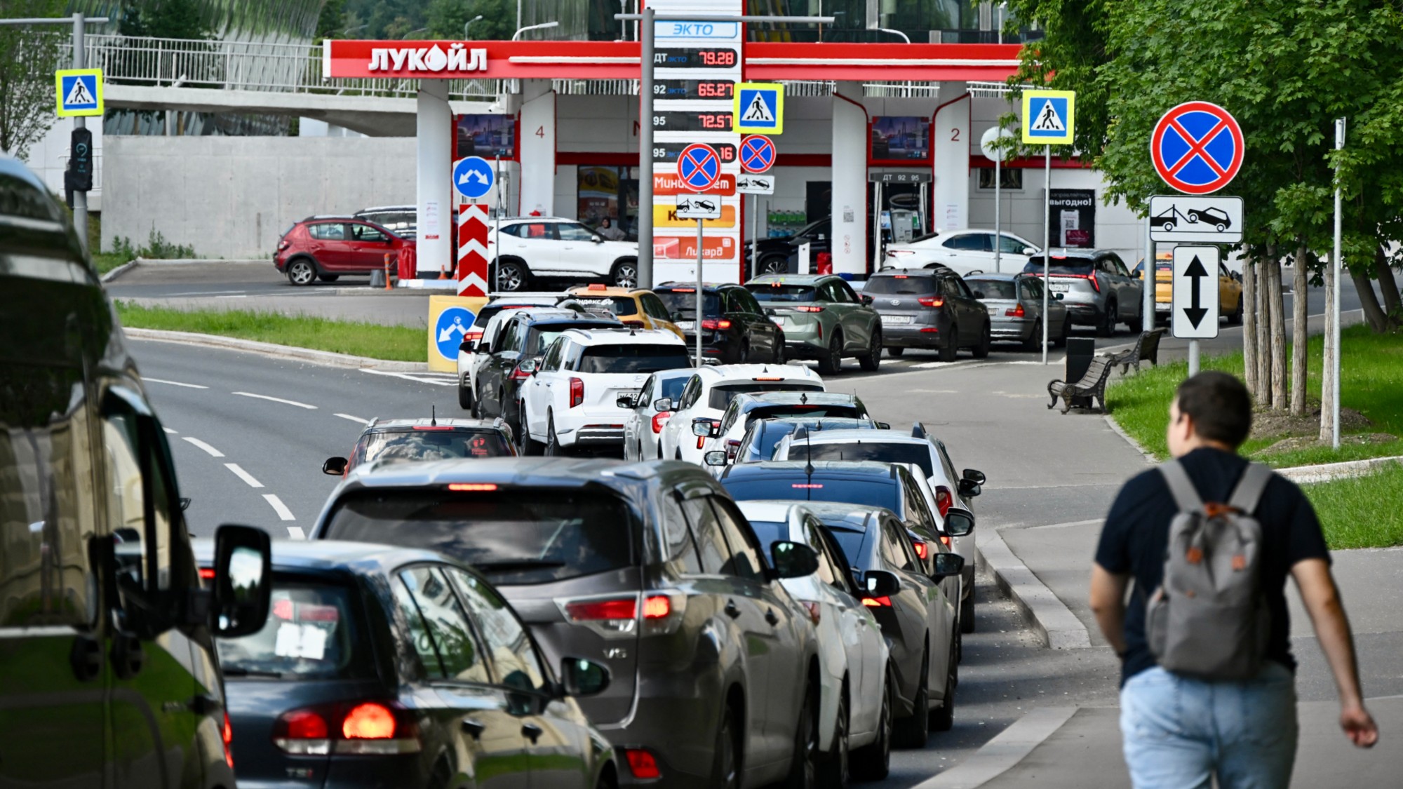 Cars wait in a long line at a Moscow gas station amid fuel shortages.