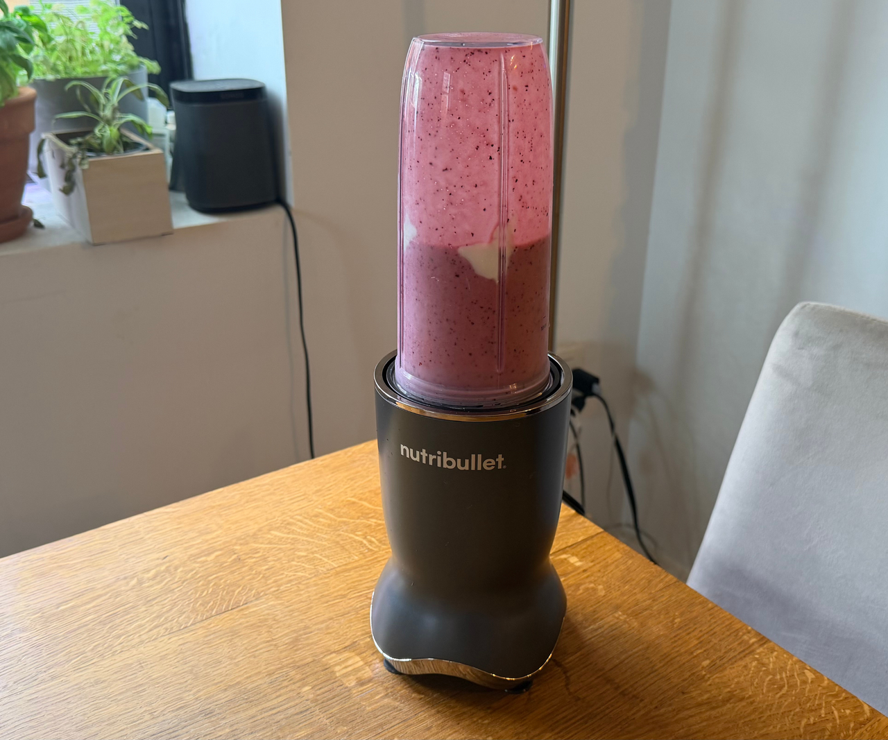 Nutribullet Ultra Plus blending a pink smoothie