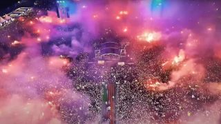 An aerial shot of a huge crowd with dozens of bright red flares dotted around the venue