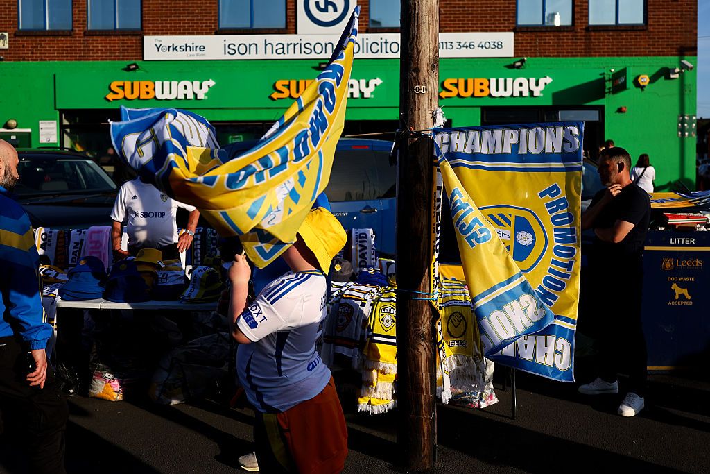 Leeds United promotion 2024/25 flags being sold at a merchandise stall ahead of the Sky Bet Championship match between Leeds United FC and Bristol City FC at Elland Road on April 28, 2025 in Leeds, England.