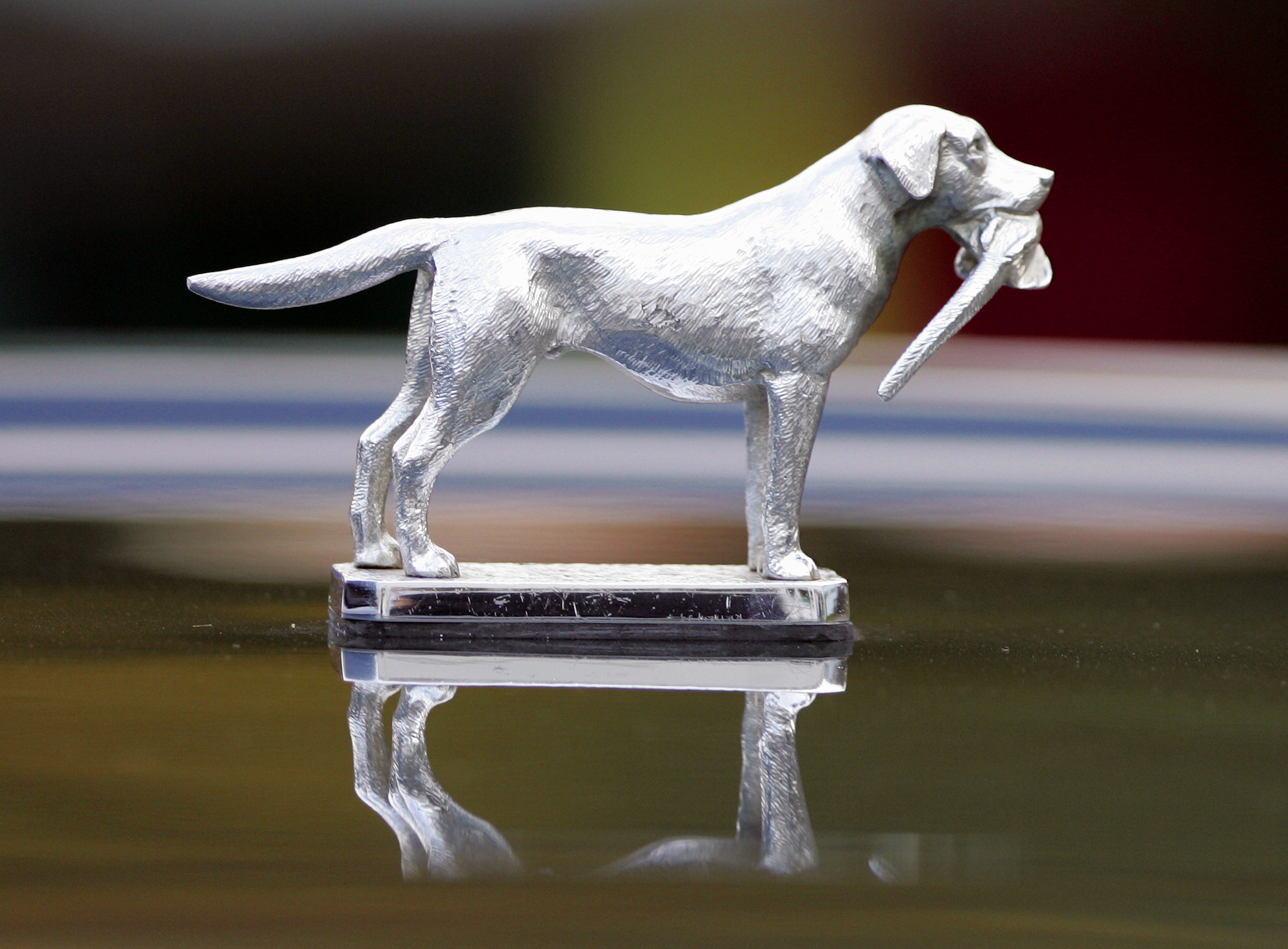 The Queen's Range Rover hood ornament of a dog holding a bird