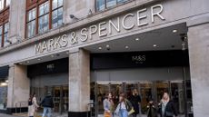 Pedestrians walk past a Marks & Spencer (M&S) storefront on Oxford Street, London.