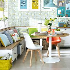 living room with wooden seating and multi colour cushions