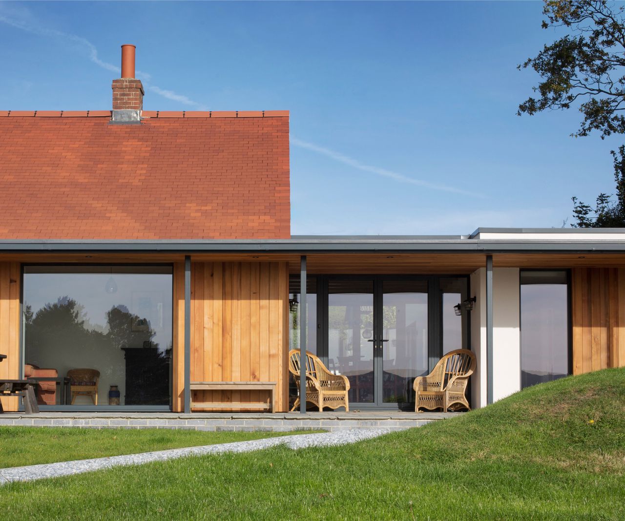 before and after shot of home and garage conversion linked by glass fronted corridor