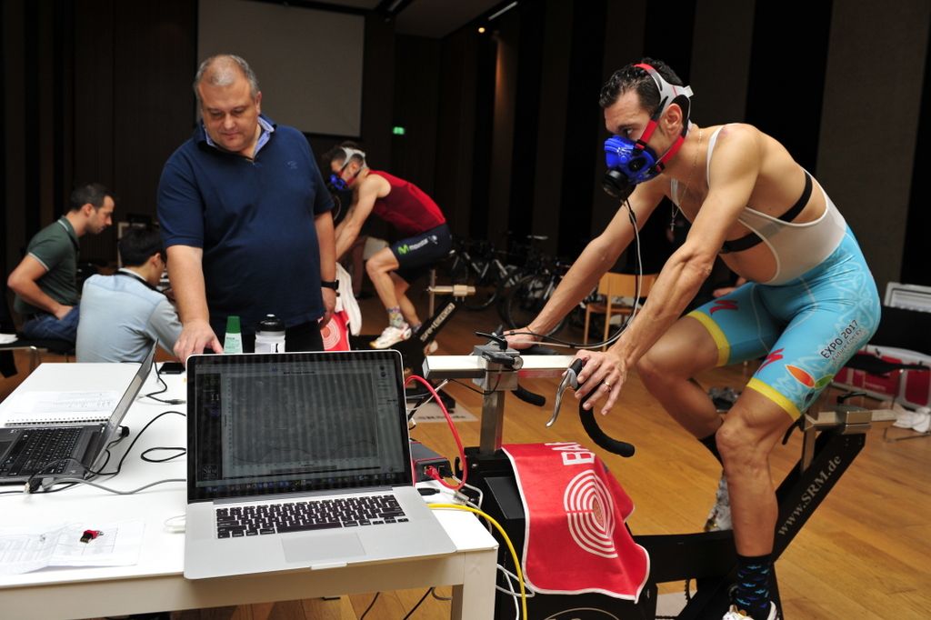 Paolo Slongo checks the files as Vincenzo Nibali undergoes a medical test