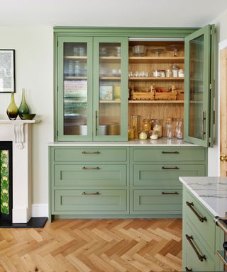 Light green pantry with glass window, wood exterior