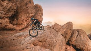Mondraker Dune XR being ridden on rocky desert landscape