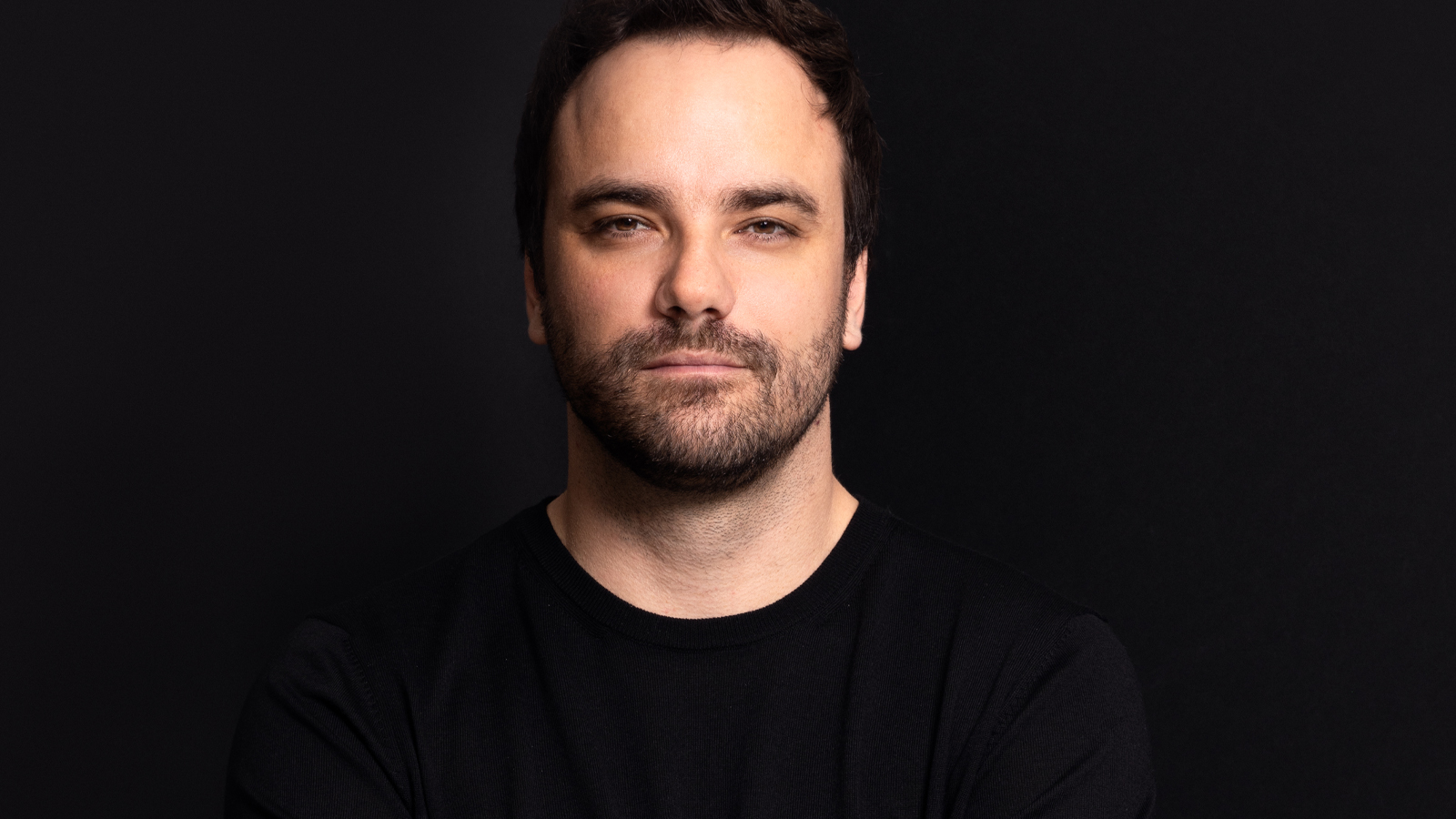 A photo of a man against a black background