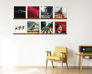 a vinyl wall with a yellow chair underneath on a white wall