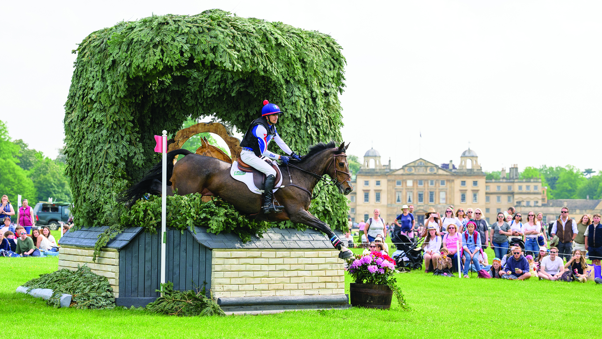 Gaspard Maksud and Zaragoza jump a corner fence in front of the house at Badminton Horse Trials 2026