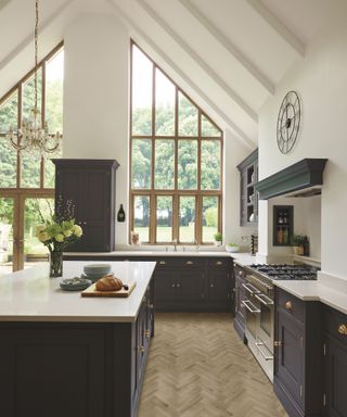Broken-plan kitchen designed by interior designer, Tom Howley with kitchen island and tiles