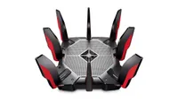 TP-Link Archer AX11000 wireless router shown on a white background. The router is black, grey, silver and red and is shown from isometric viewpoint.