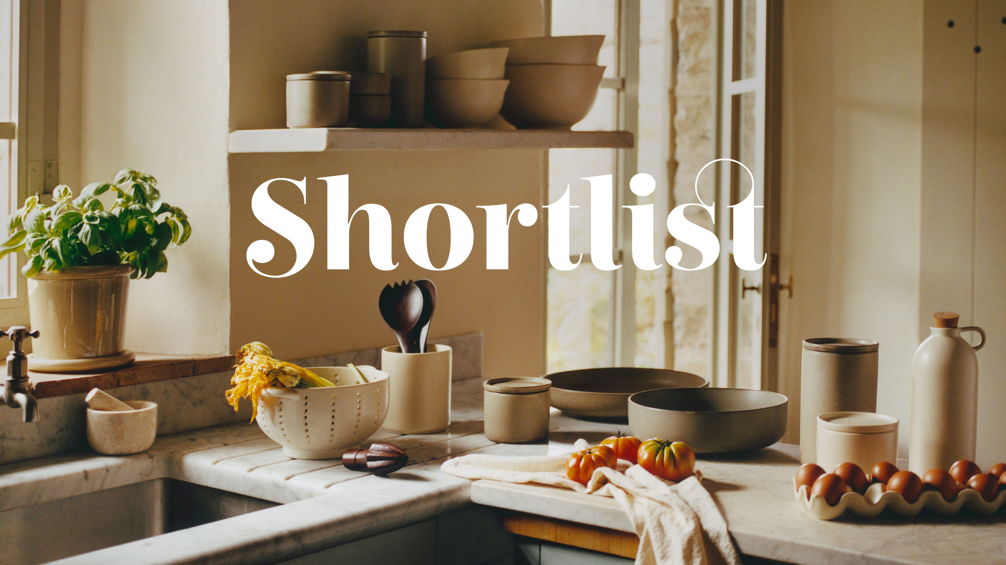 H&amp;M cooking collection with mango wood rolling pin, ceramic oil pourer and mixing bowl on a marble worktop