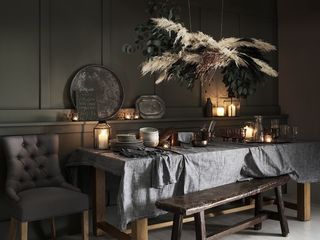 Christmas New Year decorating ideas with a hanging garland over the table by The Cotswold Co