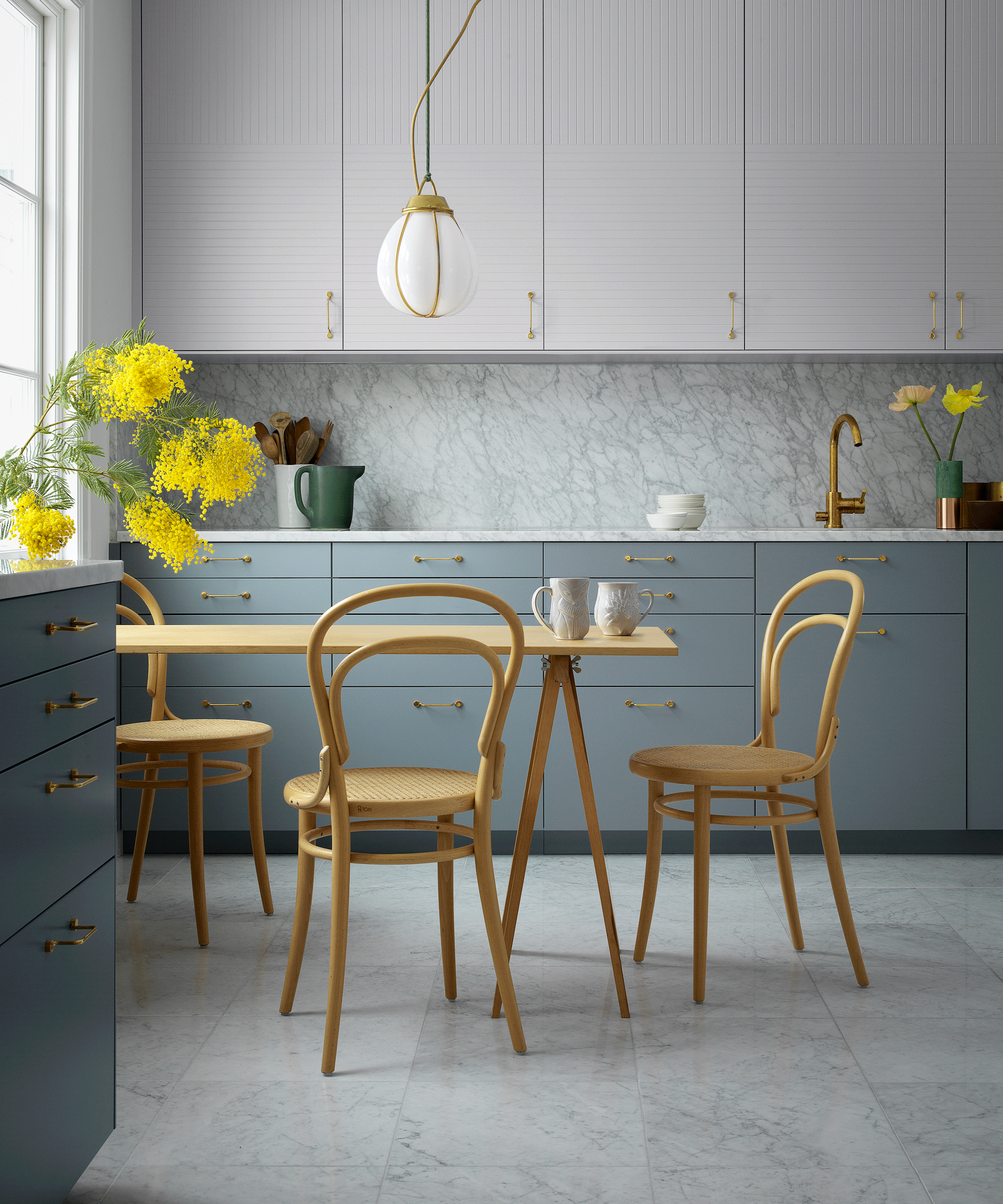 Two-tone kitchen with soft blue and white cabinetry