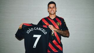 Manchester City star Joao Cancelo proudly shows off his No.7 shirt