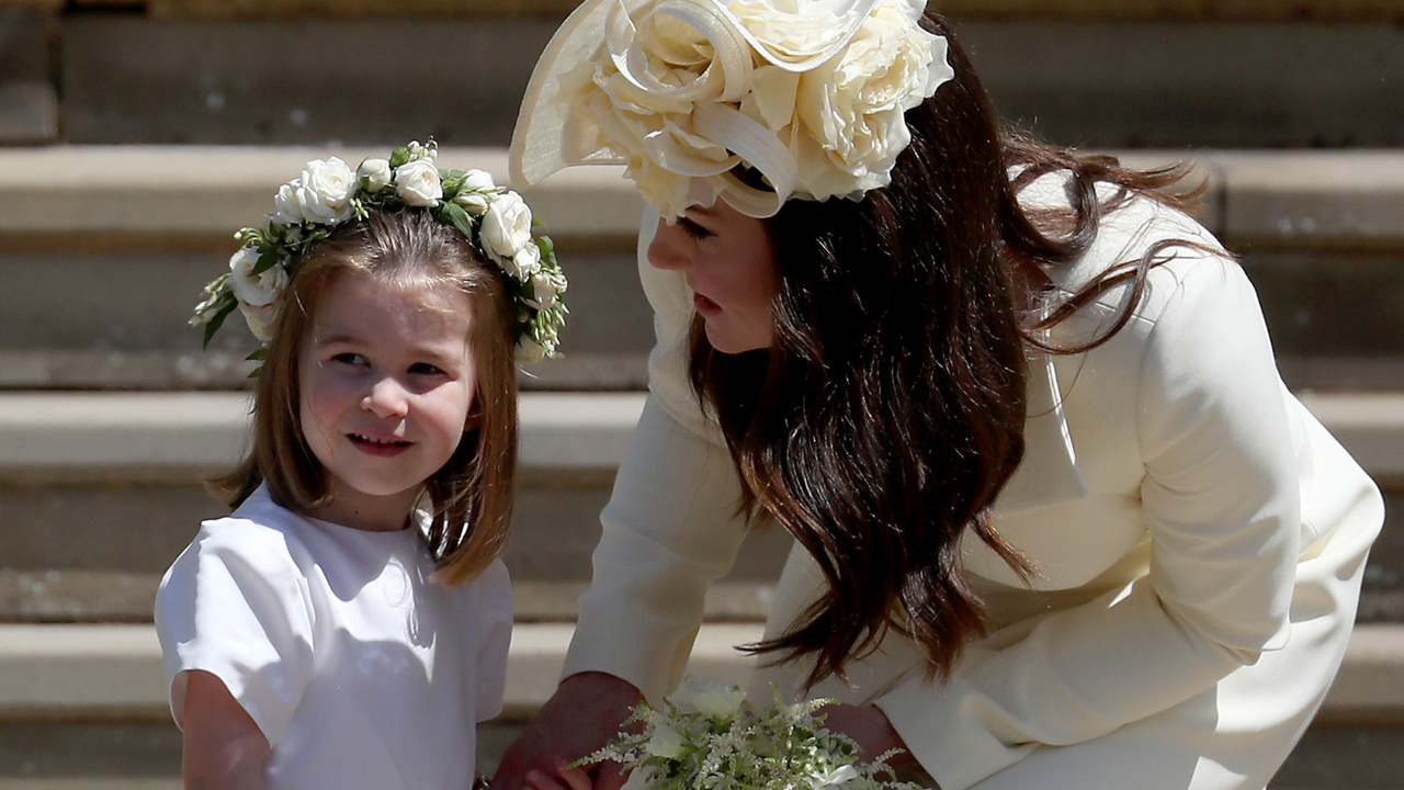 Princess Charlotte of Cambridge stands on the steps with her mother Catherine, Duchess of Cambridge after the wedding of Prince Harry and Ms. Meghan Markle at St George&#039;s Chapel at Windsor Castle on May 19, 2018 in Windsor, England.