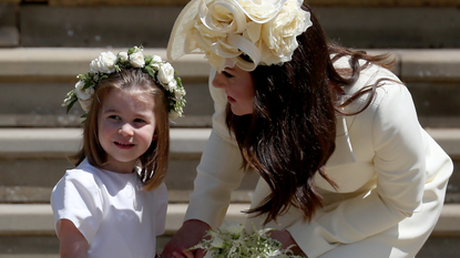 Princess Charlotte of Cambridge stands on the steps with her mother Catherine, Duchess of Cambridge after the wedding of Prince Harry and Ms. Meghan Markle at St George's Chapel at Windsor Castle on May 19, 2018 in Windsor, England.