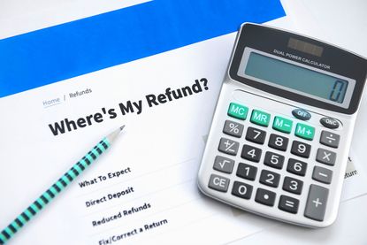 Calculator and a printed-out web page titled "Where's my refund?"