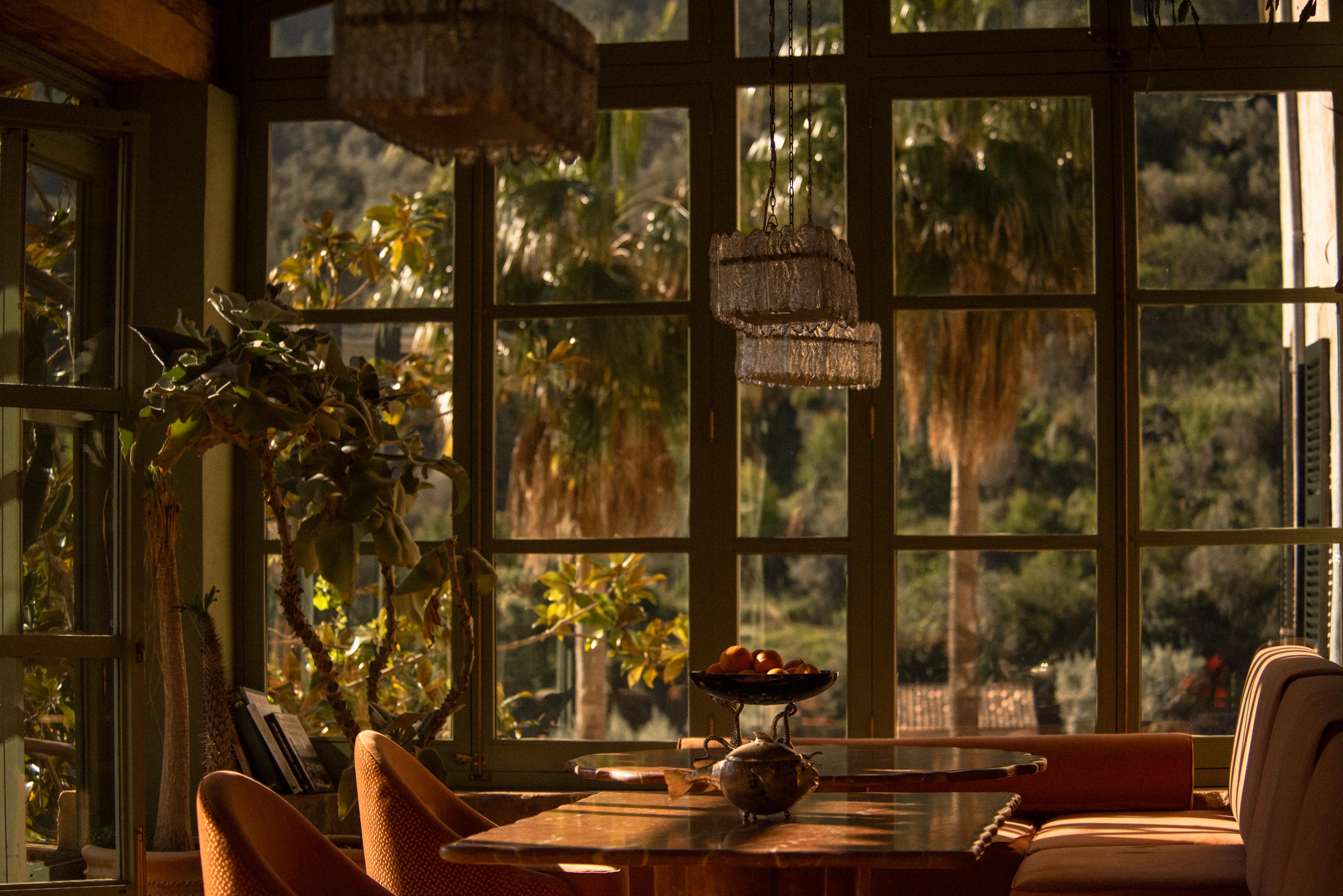 upholstered seating, tables and steel frame chairs on sunny terrace restaurant