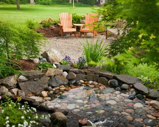 Backyard pond with chairs