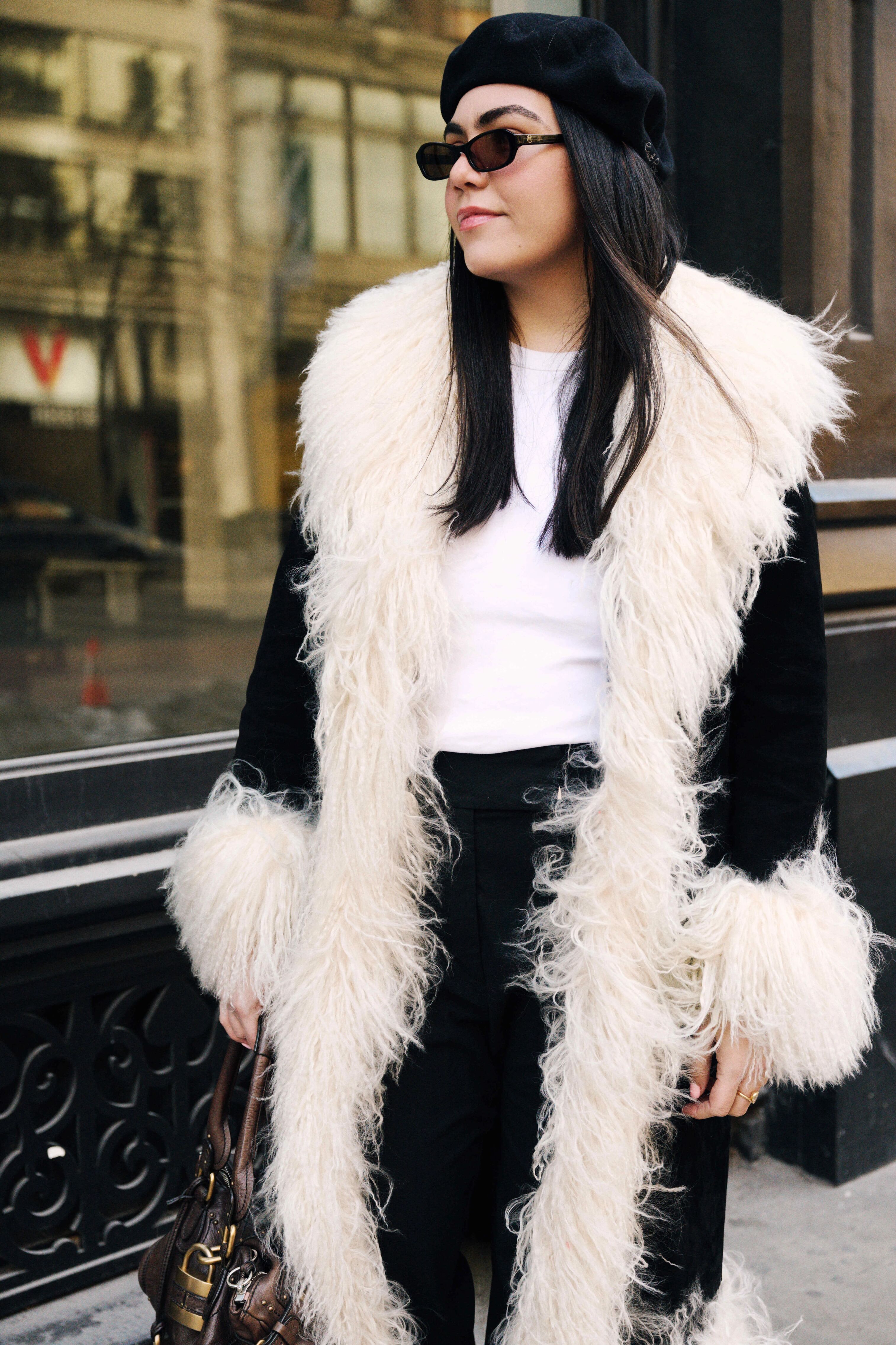 a woman wears a furry coat