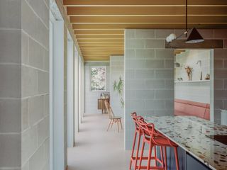 Triangle House by Artefact showing colour interiors and a graphic architectural approach that blends rawness and colour