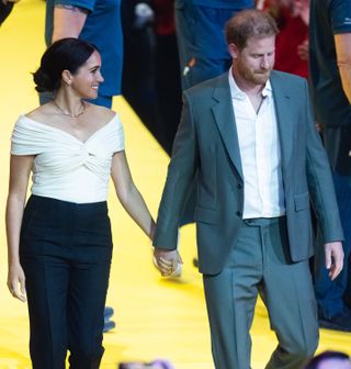Prince Harry and Meghan Markle hold hands