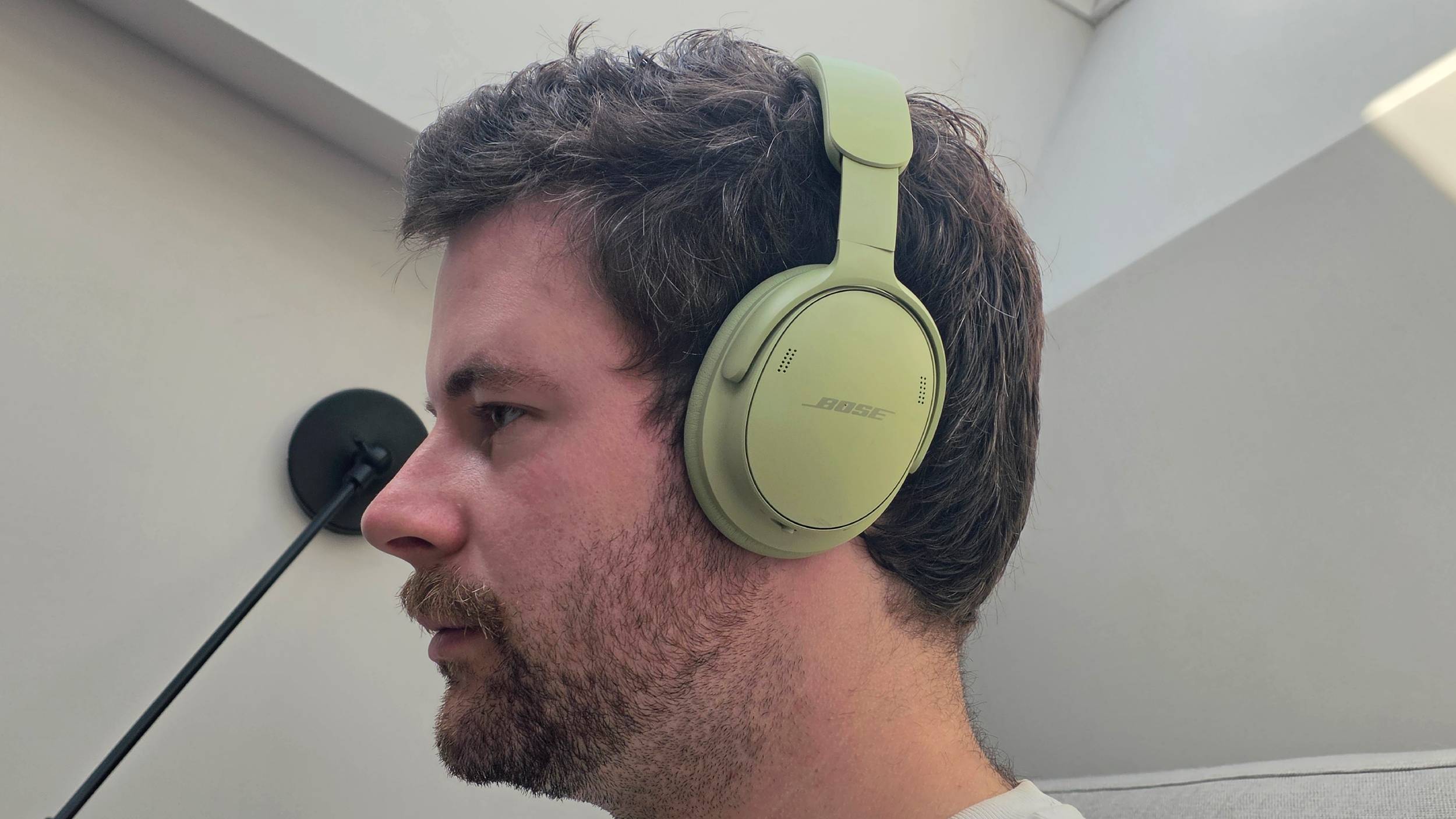 The Bose QuietComfort Headphones (2nd Gen) on a man's head.