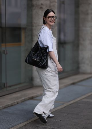 woman wearing overalls and a T-shirt