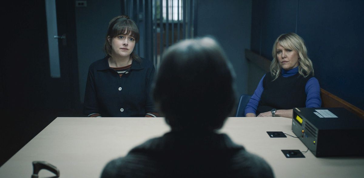 Tosh (Alison O&#039;Donnell) and Calder (Ashley Jensen) sit in a police interview room across the table from Grace Bain (Phyllis Logan), who has her back to the camera