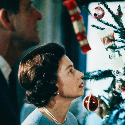 Christmas at Windsor Castle is shown here with Queen Elizabeth II and Prince Philip shown putting finishing touches to Christmas tree, in a photo