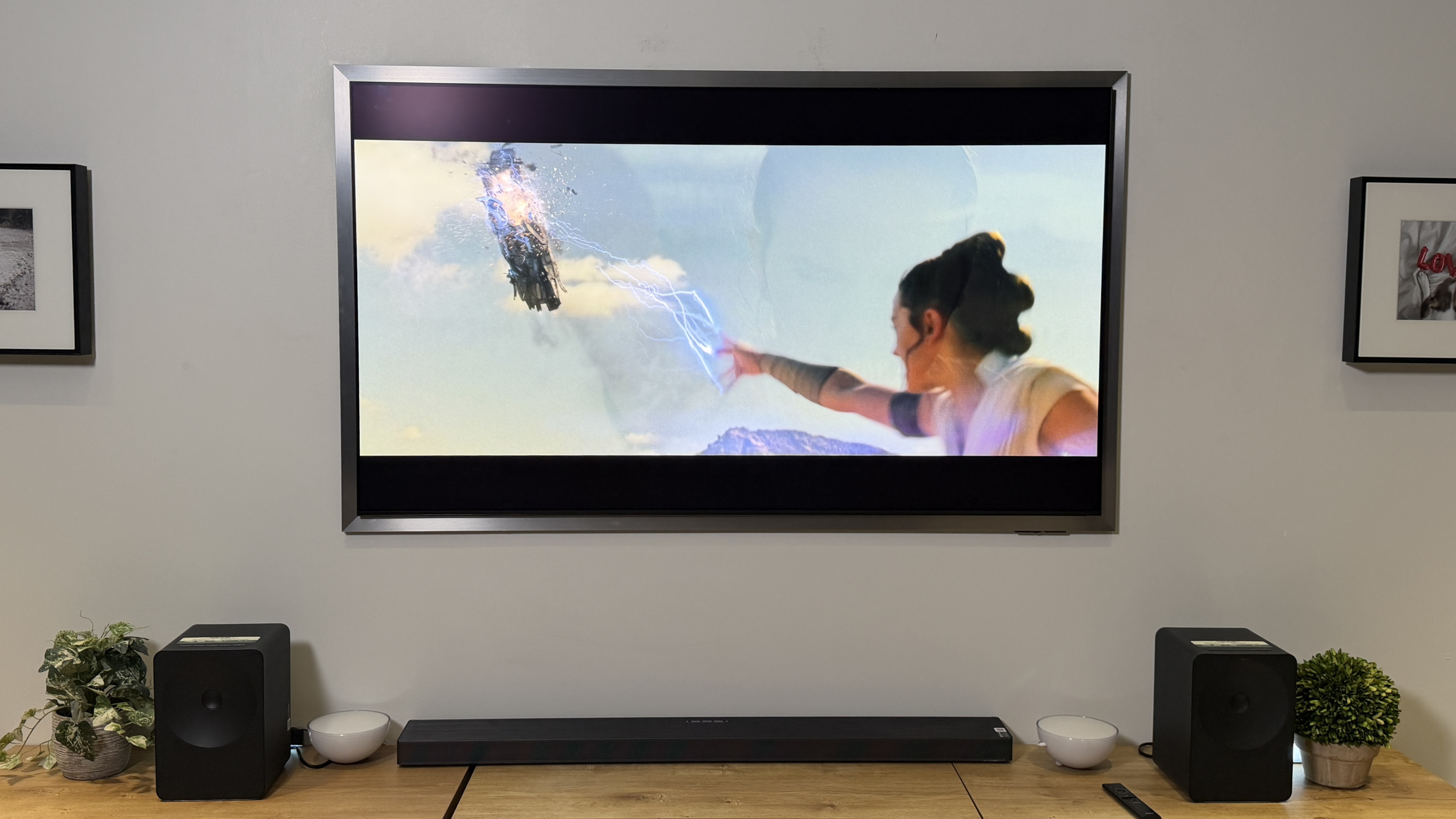 The Samsung S95H OLED TV in a wall-mounted position displaying a scene from "Star Wars: The Rise of Skywalker"